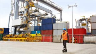 A longshoreman walking away from cargo containers