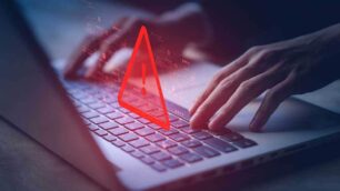 A person typing on a laptop