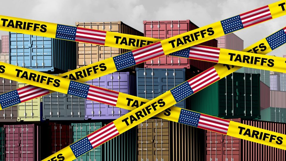 Cargo containers with yellow tape that says tariffs