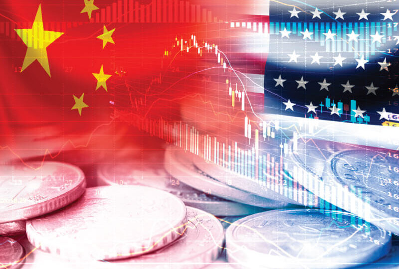 The U.S. and Chinese flag with coins on a table
