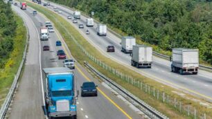 Semi trucks and other vehicles going down a highway