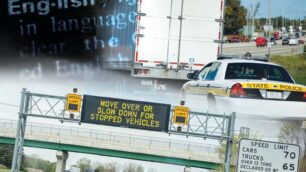 A police car pulling over a semi truck on a highway