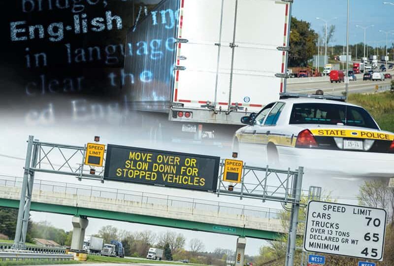 A police car pulling over a semi truck on a highway