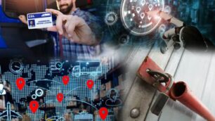 A truck driver holding their CDL, a robot hand, a map, and a locked dry van trailer